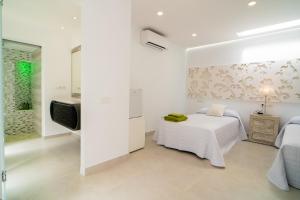 A bed or beds in a room at Villa Views Can Funtasa II
