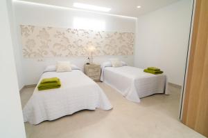 A bed or beds in a room at Villa Views Can Funtasa II