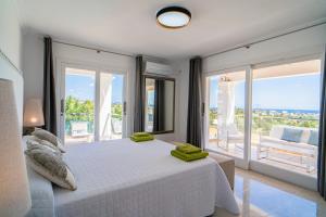 A bed or beds in a room at Villa Views Can Funtasa II