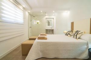 A bed or beds in a room at Villa Views Can Funtasa II