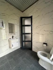 a bathroom with a toilet and a sink at Twenty ritz in Migori +26 photos