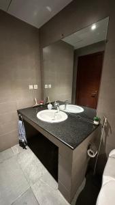a bathroom with two sinks and a large mirror at Luxury Studio Apt in Gulberg with City Views in Lahore +8 photos