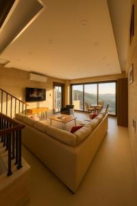 a living room with a long couch and tables at Jordan Castle Resort in Irbid +44 photos