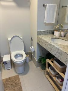 a bathroom with a toilet and a sink at Loft Boa Viagem - Uni Studios in Niterói +19 photos