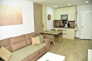 a living room with a couch and a dining room at Silver Dream 1 in Veliko Gradište