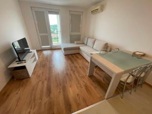 a living room with a couch and a table at Fortuna Cape 4 apartment in Byala