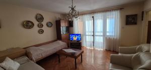 a living room with a couch and a tv at Senia Retro in Senj