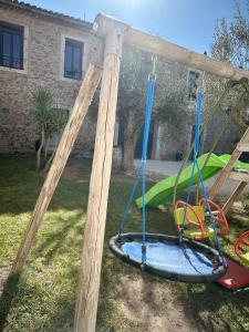 a playground with a swing set in a yard at Au cocon des Corbière - La bohème in Lézignan-Corbières