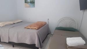 Ένα ή περισσότερα κρεβάτια σε δωμάτιο στο Aconchego Bertavile 01 a minutos do aeroporto