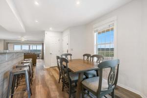 a dining room with a wooden table and chairs at Ozark Mountain Oasis - For 7 in Kimberling City