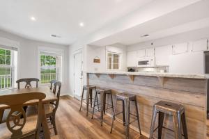 a kitchen with a table and stools in a room at Ozark Mountain Oasis - For 7 in Kimberling City