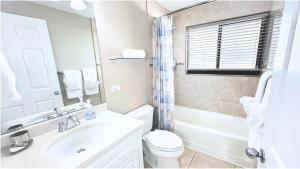 a bathroom with a sink and a toilet and a mirror at 3Bed Oceanview with Pool on Seven Mile Beach in Seven Mile Beach +12 photos
