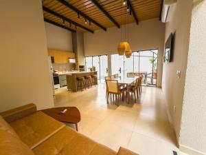 a living room with a couch and a table with chairs at Halmá Homes in Bonito