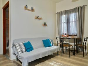 a living room with a couch and a table at Panos Apartment in Kontokali
