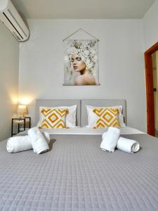 a bedroom with a large bed with two pillows at Panos Apartment in Kontokali