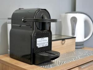 a black coffee machine sitting on a counter at Panos Apartment in Kontokali