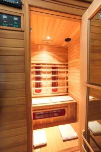 a sauna with wood paneling and towels in it at Bru Chlann Lir in Belmullet