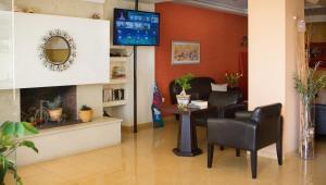 A television and/or entertainment centre at Xenios Loutra Village Beach Hotel