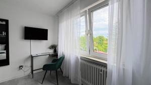 TV a/nebo společenská místnost v ubytování Hola Hotel Stuttgart