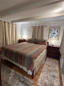 ein Schlafzimmer mit einem Bett mit zwei Nachttischen und zwei Lampen in der Unterkunft Chillshack in Abbeyville