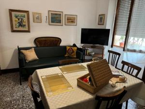 a living room with a table and a couch at La casa di Angel in Calangianus