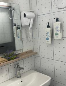 a bathroom with a sink and a mirror at Vila18 Vlore in Vlorë