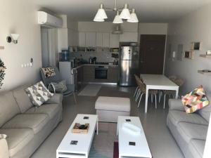 a living room with a couch and a table at Marassi marina 2 in El Alamein
