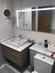 a bathroom with a sink and a mirror and a toilet at Marassi marina 2 in El Alamein