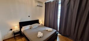a bedroom with a bed with two towels on it at Vip Panoramic view in Athens