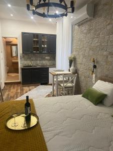 a bedroom with a bed and a table with a bottle of wine at Diokletian's Golden Nest in Split +13 photos