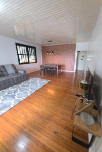 a living room with a couch and a table at Alpen Haus - Ideal para família e grupo in Santa Rosa