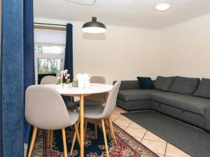 a living room with a table and a couch at 2 person holiday home in Højer in Højer +33 photos