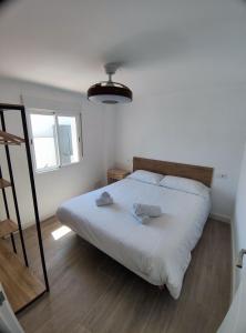 a bedroom with a bed with two towels on it at La Casita de Isabel, Near Ronda, Sierra de Grazalema in Montecorto +13 photos