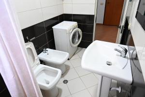 a bathroom with a toilet and a sink at Beach Apartments - Shengjin in Shëngjin +15 photos