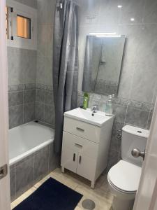 a bathroom with a sink and a toilet and a bath tub at Panoramic Views Cozy Apt Benalmádena Center in Benalmádena