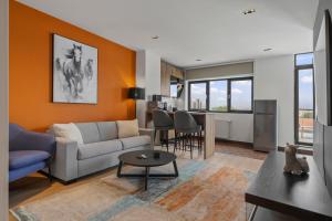 a living room with a couch and a table at Uni88 Apart Hotel in Bucharest