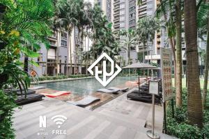 a swimming pool in a building with palm trees at Designer Luxury 3BR Retreat near Pavilion & KLCC in Kuala Lumpur