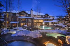a house with a swimming pool in the snow at Grand Timber Lodge in Breckenridge