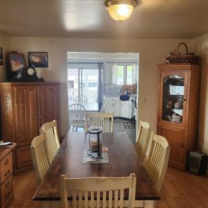 una cucina e una sala da pranzo con tavolo e sedie in legno di Peacehouse ad Abbeyville