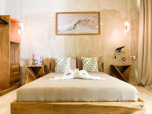 a bedroom with a bed with two towels on it at Moringa Private Room in General Luna