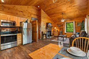 a kitchen and living room in a log cabin at Black Bear Cove in Gatlinburg
