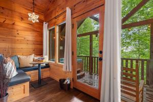 a screened in porch of a log cabin at Black Bear Cove in Gatlinburg