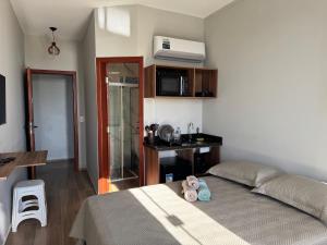 a bedroom with a bed with two shoes on it at Apartamento de frente para lagoa -AP 102 in Laguna