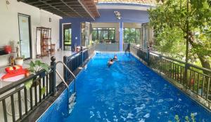 a pool in a house with people in the water at A Thía homestay in Diện Biên Phủ