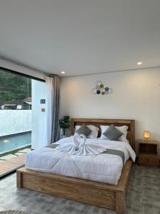 a bedroom with a large bed with white sheets at Heaven House Kintamani in Kubupenlokan +130 photos