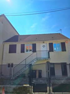 a house with a staircase in front of it at Grand studio cosy proche Paris in Épinay-sur-Seine