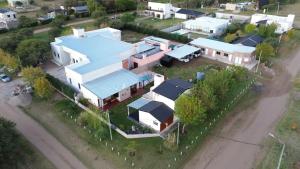 an aerial view of a house with a blue roof at Cabañas bajos medanales in Victorica