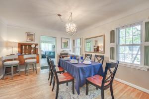 a dining room and kitchen with a table and chairs at Historic University Heights Home with Private Yard! in University Heights