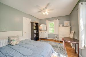 a bedroom with a blue bed with a teddy bear on it at Historic University Heights Home with Private Yard! in University Heights