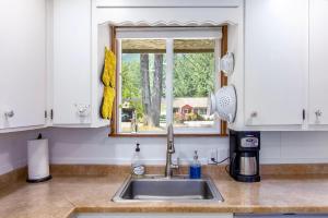 a kitchen counter with a sink and a window at Peak View | White Pass, Mt Rainier in Packwood +45 photos